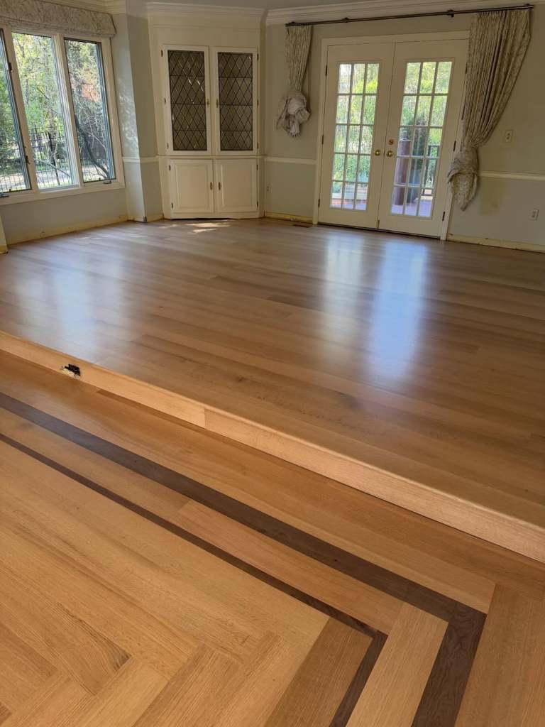 Installed 6 inch rift quarter sawn red oak with a walnut border from @hickmanwoods . Glue and 9